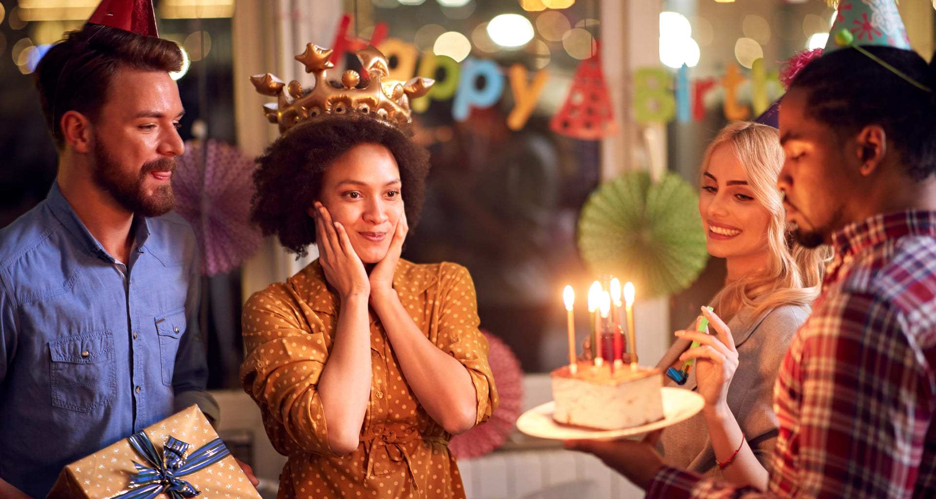 Surprised birthday girl looking at cake